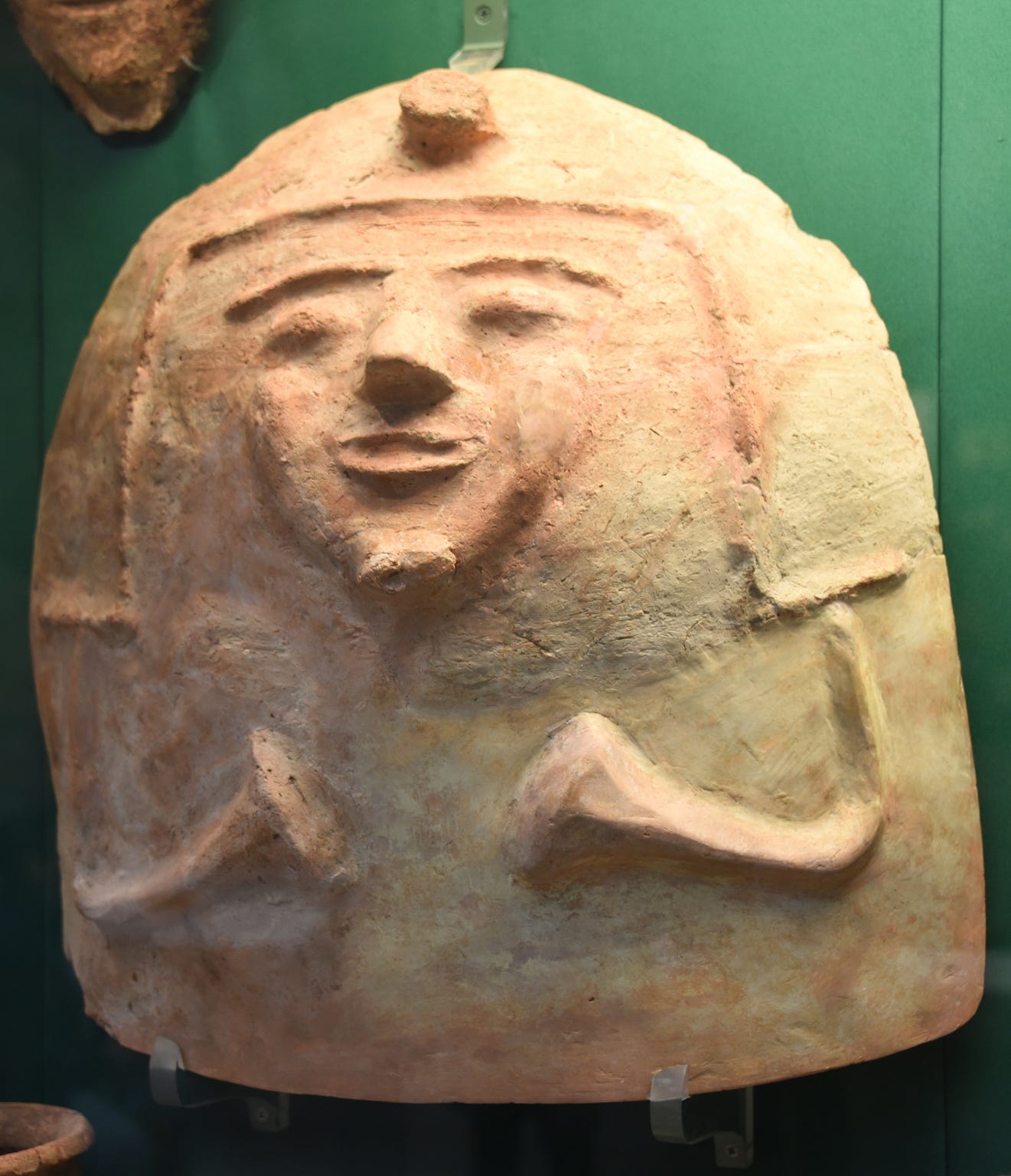 Ancient Philistine artifact showing a detailed ceramic helmet or headgear in a museum display