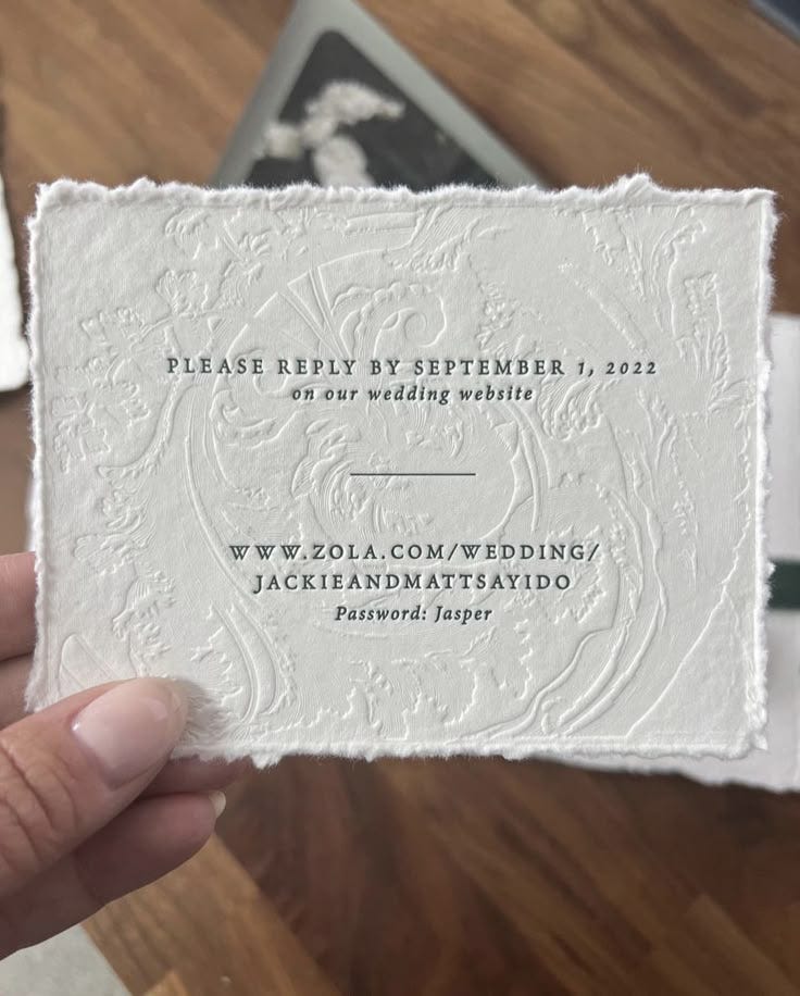 This may contain: a person holding up a business card in their hand