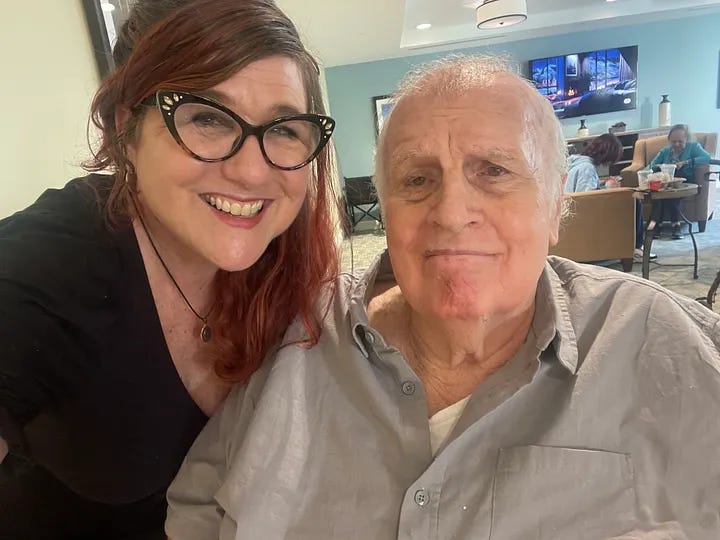An adult woman and her elderlly father