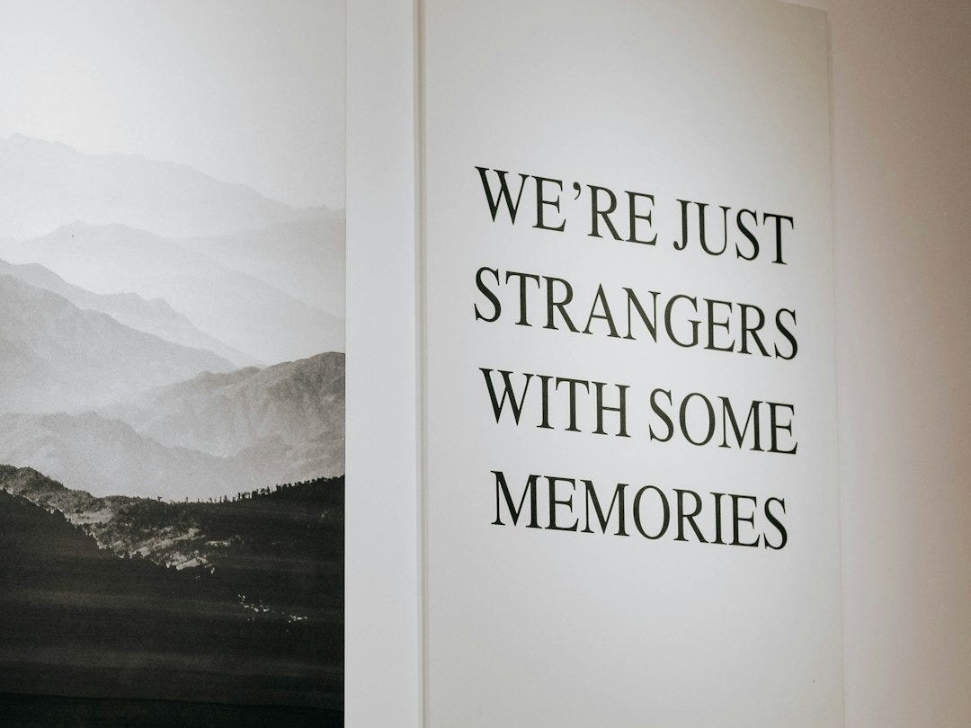 black framed white and gray mountains painting