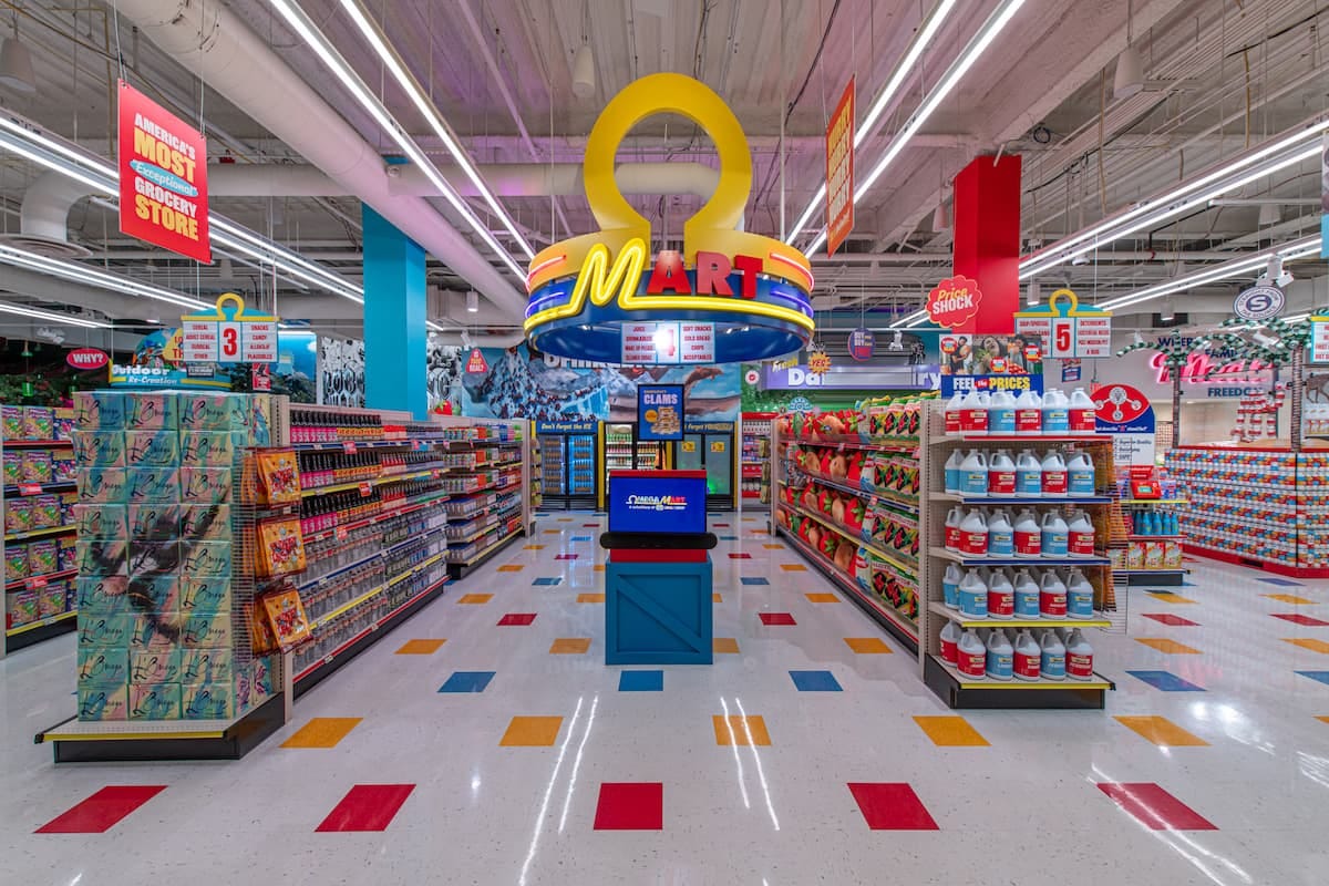 Interior of Omega Mart in Las Vegas, featuring neon aisles and signs, with surreal products that blend retro aesthetic with an artistic twist.