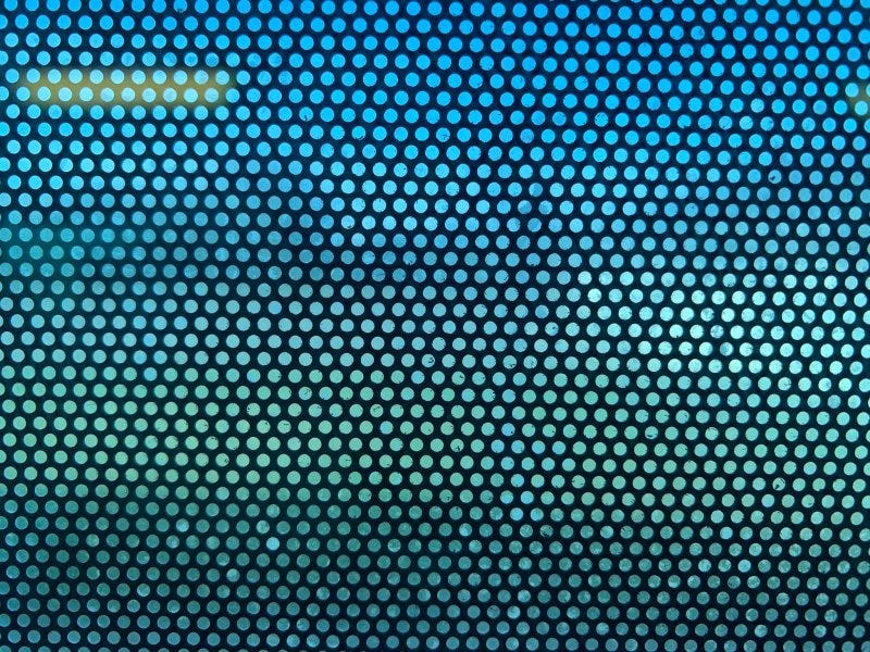 View from inside a bus looking through a perforated ad, which largely obscures the outside view View from inside a bus looking through a perforated ad, which largely obscures the outside view