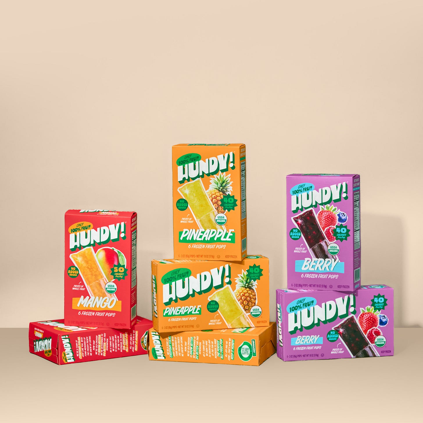 red, orange and purple Hundy boxes piled in front of a tan background red, orange and purple Hundy boxes piled in front of a tan background