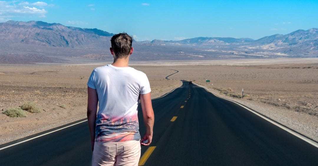 man standing in the middle of the road