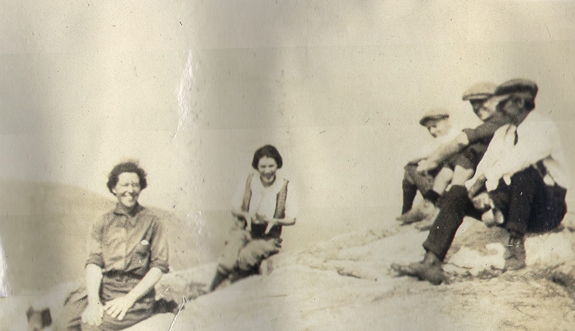 five people on mountain summit