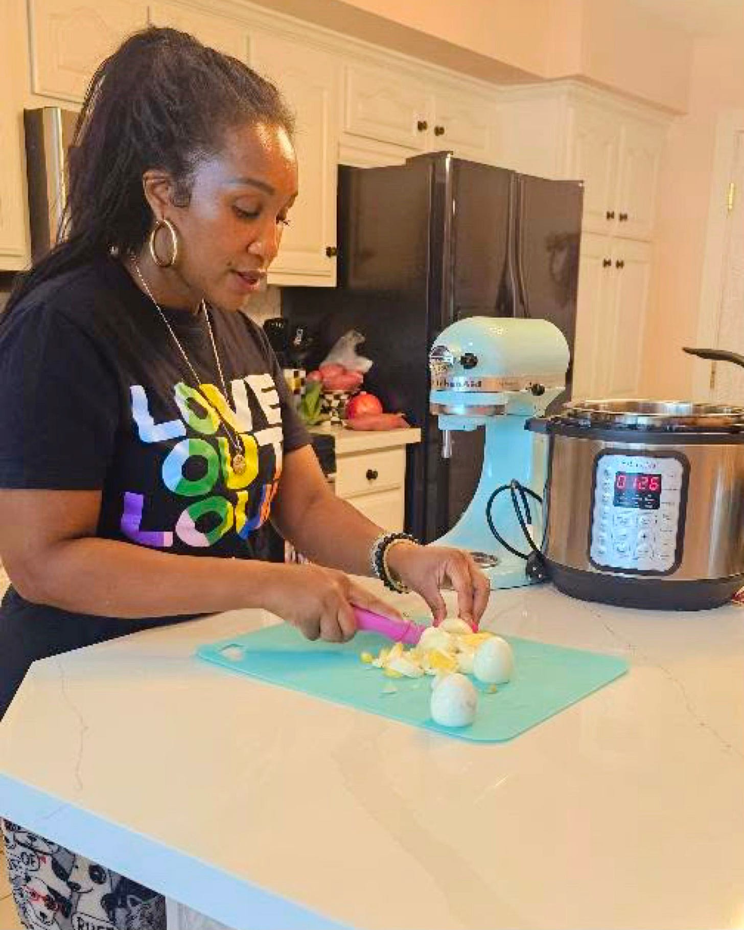 Cutting hard-boiled eggs for Southern potato salad, showing traditional soul food preparation techniques rooted in Black culinary culture
