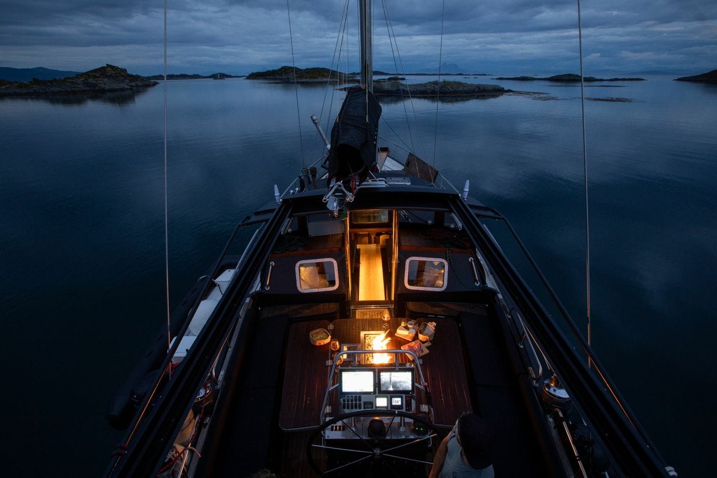 Adventure Norrøna illuminated at night while anchored in a Norwegian fjord. Adventure Norrøna illuminated at night while anchored in a Norwegian fjord.