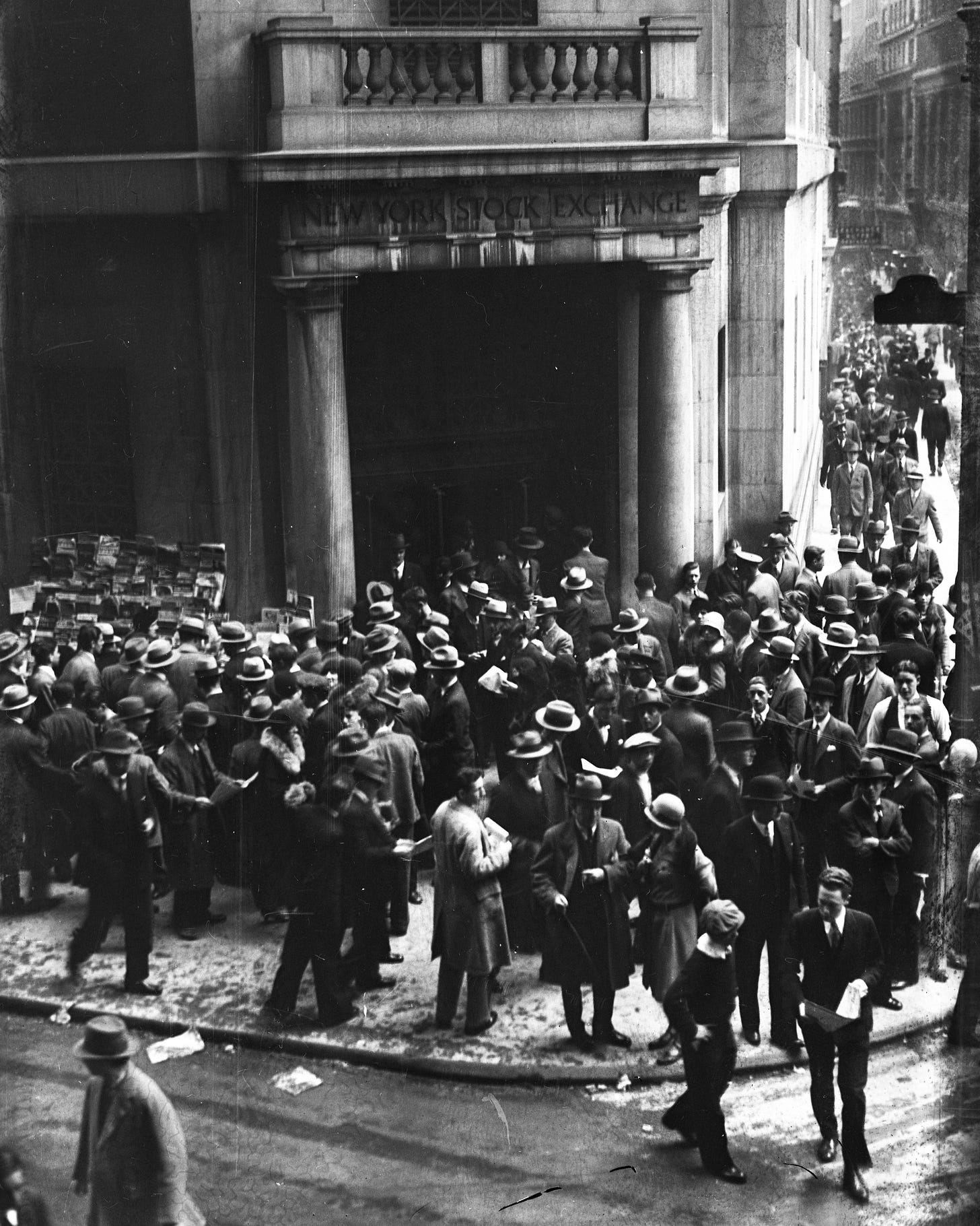 Crowds of people gather outside the New York Stock Exchange on Wall Street after the Stock Market Crash on 1929. The Roaring Twenties, a time of wealth and excess, has been claimed to be the blame of the crash that eventually led to the Great Depression. Crowds of people gather outside the New York Stock Exchange on Wall Street after the Stock Market Crash on 1929. The Roaring Twenties, a time of wealth and excess, has been claimed to be the blame of the crash that eventually led to the Great Depression.