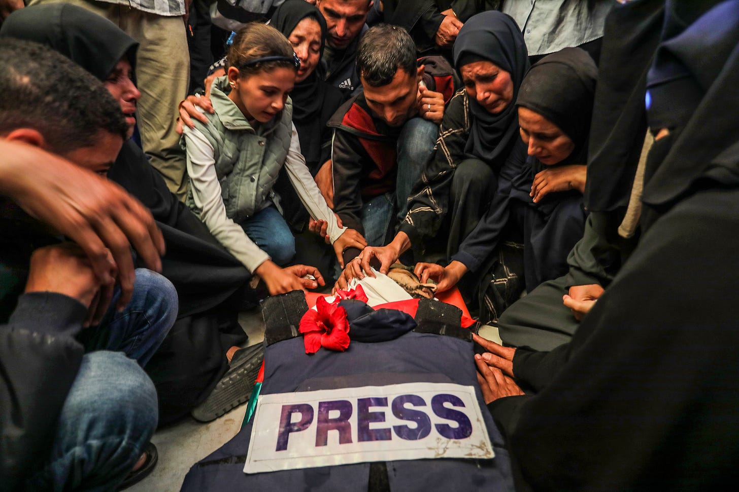 Relatives and colleagues of Palestinian journalist Hassan Eslaiah, who was killed in an Israeli drone strike on Nasser Hospital, mourn during his funeral ceremony held in Khan Yunis, Gaza on May 13, 2025. Photo by Abed Rahim Khatib/Anadolu via Getty Images.
