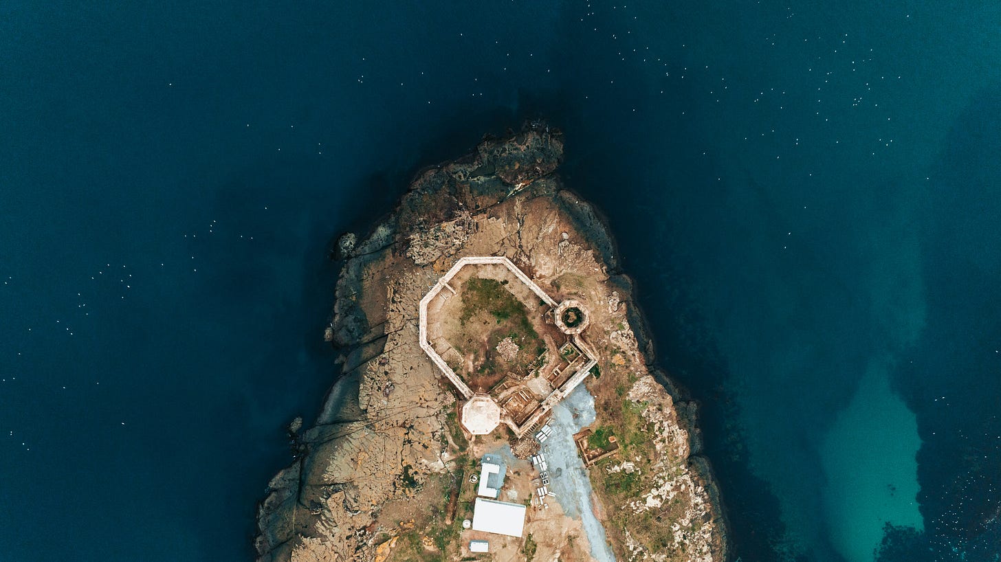 An aerial view of an island with surrounding water.