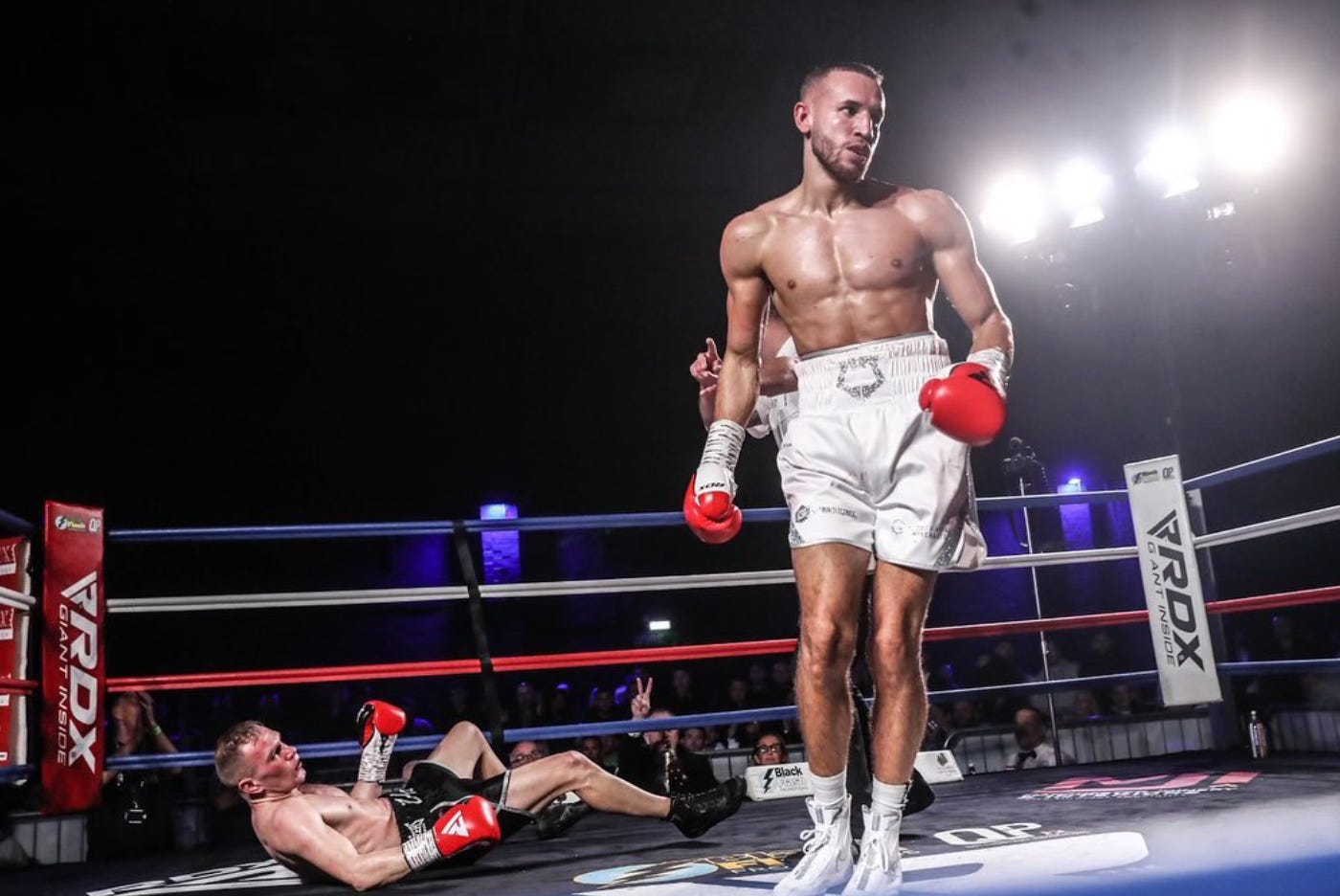 Carvell Crocker walks away from an opponent he has downed, who is flat on his back.