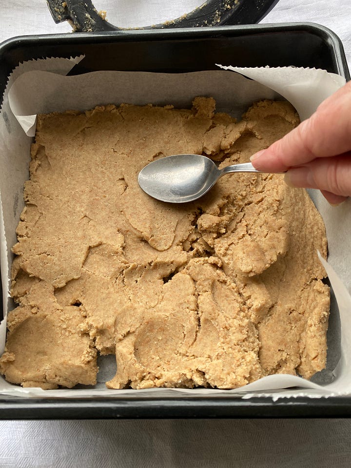 Shortbread dough in a square baking tin.