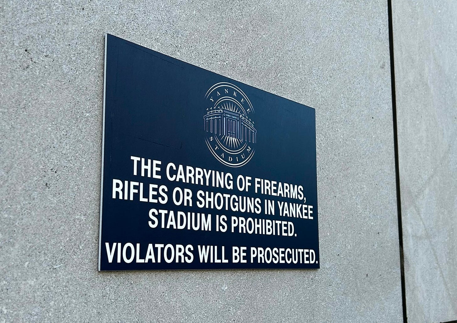 A sign outside Yankee Stadium in New York reading 'The carrying of firearms, rifles or shotguns in the stadium is prohibited'