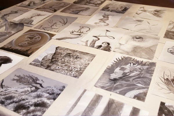 A table covered in small paintings at the event