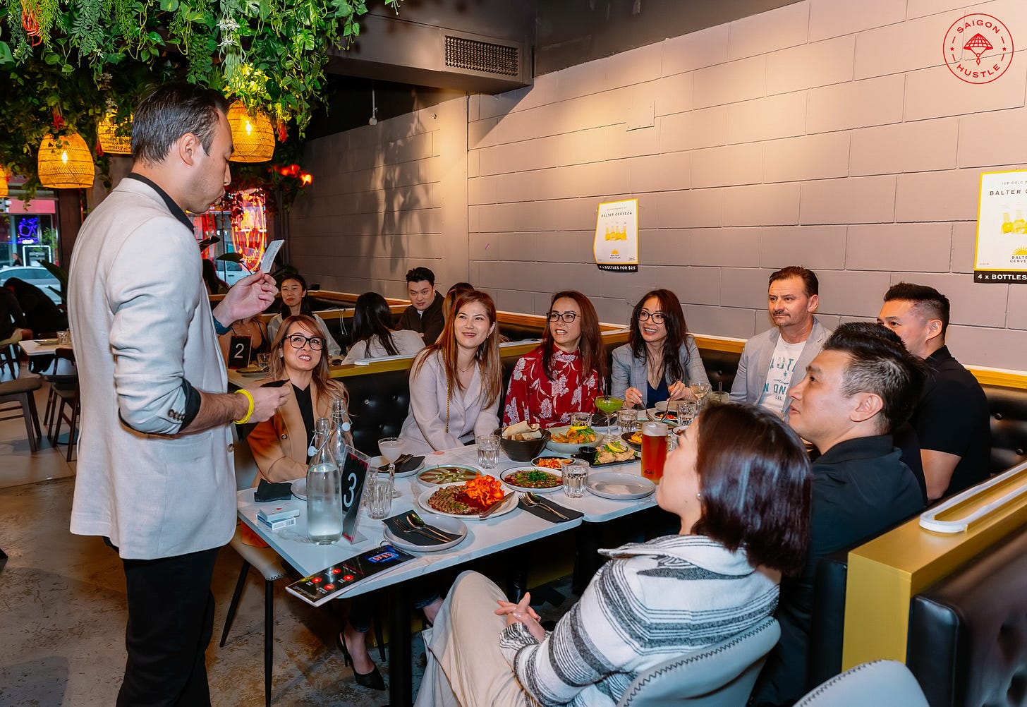 David Ung performing for a table at Saigon Hustle