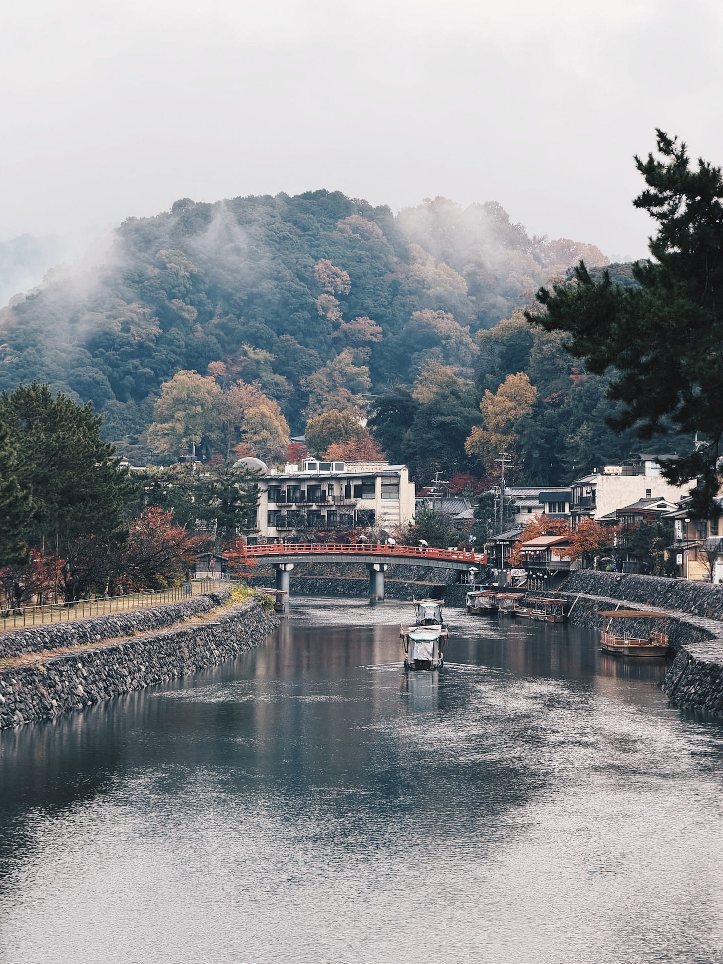 Mist rising over the Uji River with the red Asagiri Bridge and autumn foliage reflecting on the water, Uji, Japan Mist rising over the Uji River with the red Asagiri Bridge and autumn foliage reflecting on the water, Uji, Japan