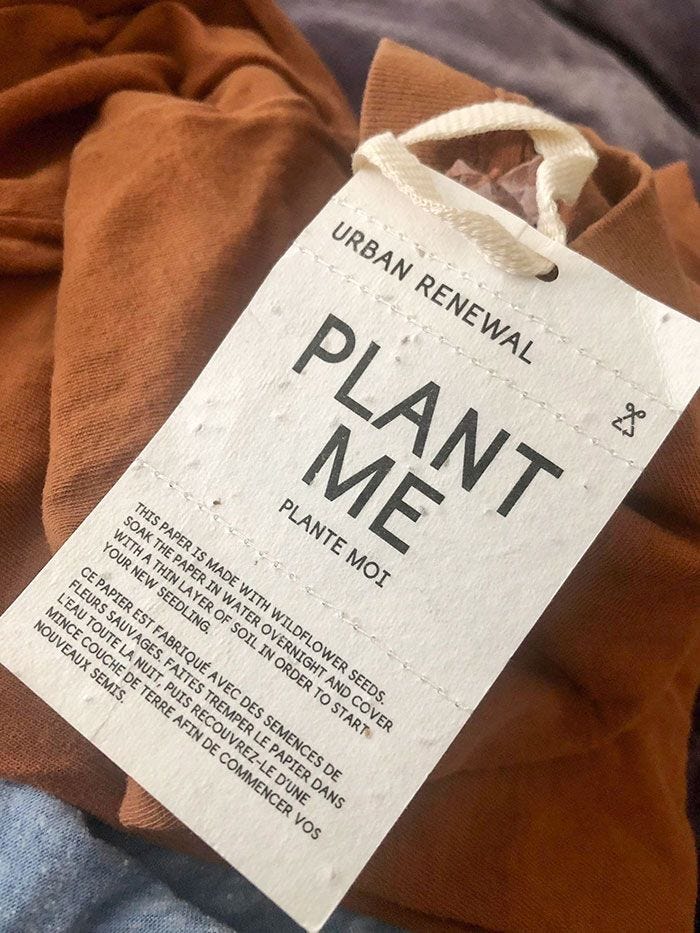 This may contain: a plant me t - shirt with a label on it
