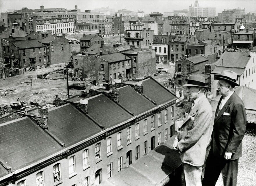 Former Mayor Raymond Tucker (at right) and then-civic leader and bond issue chairman Sidney Maestre look out over an area of Mill Creek Valley slated for clearance in this photograph from 1956.
