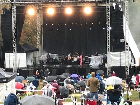 Audience scenes from 10/10/20. The show is in the rain so the crowd is sparse--sitting in Covid-safe pods. Everyone is in camp chairs. The stage is off in the distance.