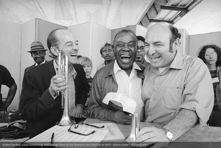 A group of men laughing at a trumpet

AI-generated content may be incorrect.