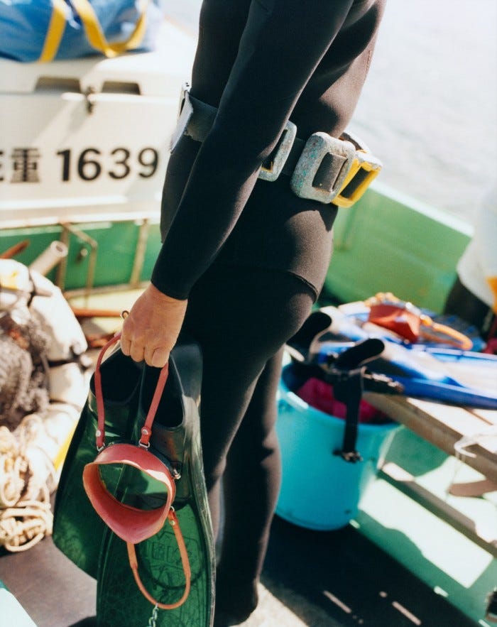 An Ama diver wearing a weighted belt