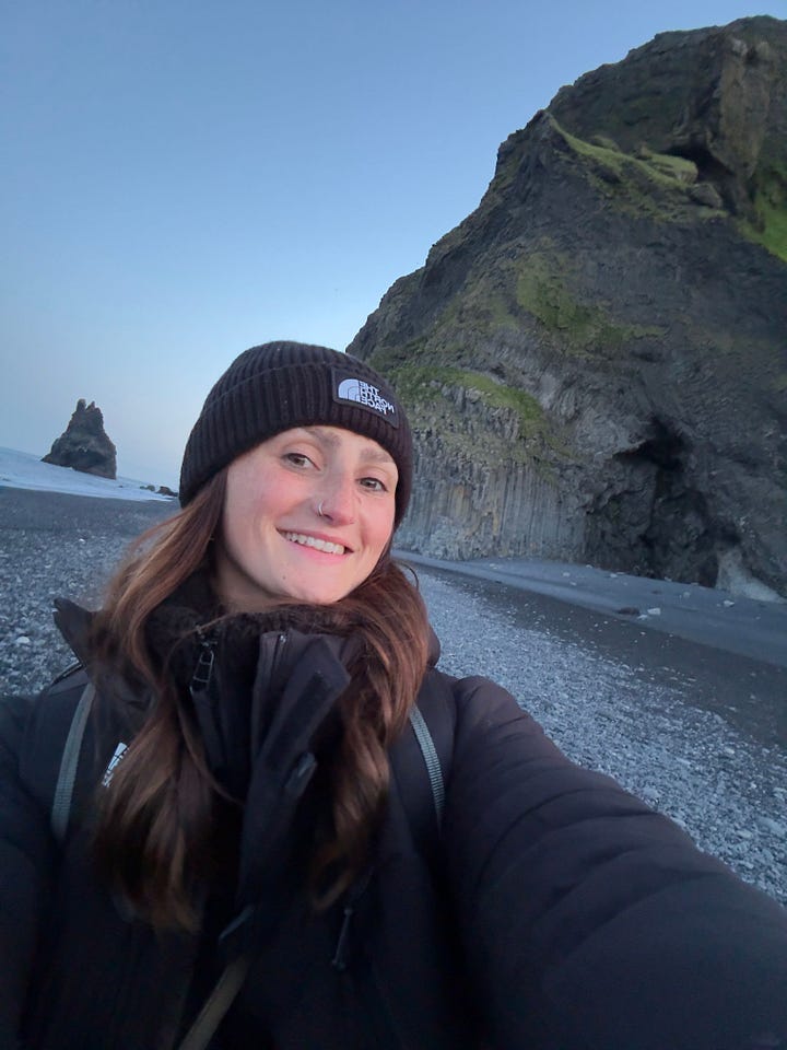 Two photos of a woman with a camera: one is a smiling selfie taken on a rocky beach with cliffs behind her, and the other shows her photographing herself in a mirrored indoor space with people reflected around her.