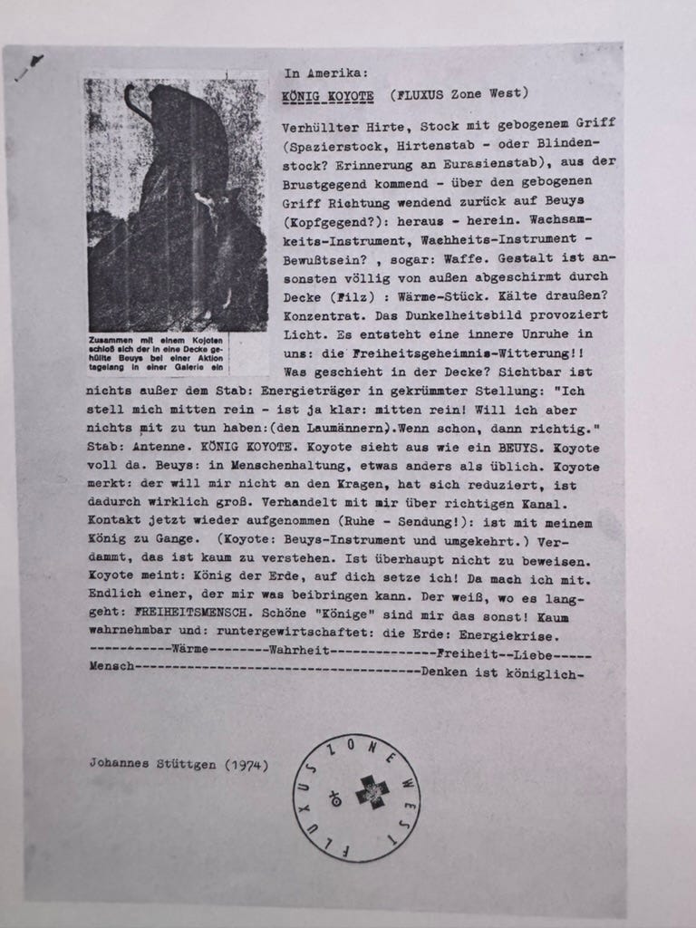 A photograph of a flyer for Joseph Beuys work, with a picture of Beuys and the coyote in the top left and a lot of text in German.