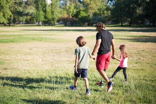 Free photo back view of father with disability walking with children. man with mechanical leg having walk in park with boy and girl. disability, family, love concept
