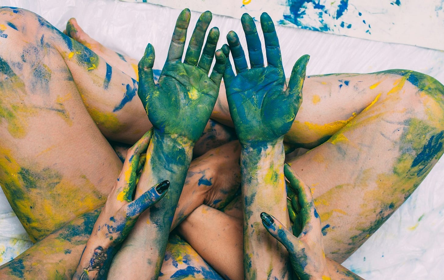 a woman covered in yellow and green paint