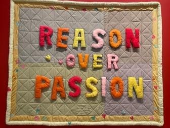 A quilt with colorful letters on it

AI-generated content may be incorrect.