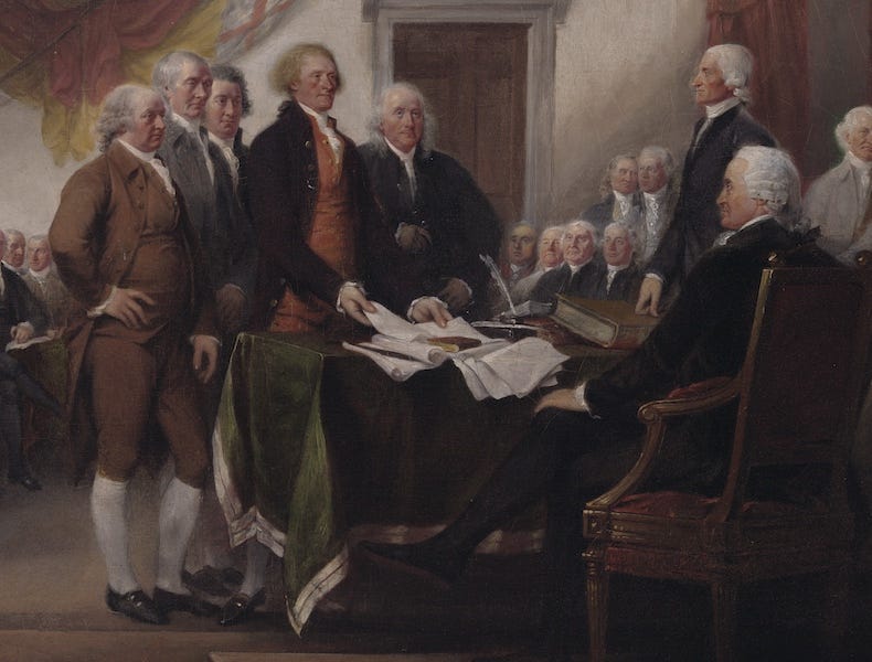 Several men in 1700s costume sign the Declaration of Independence.