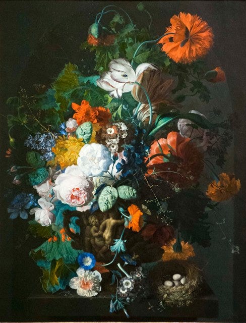 A lavish overflowing bouquet of roses and other flowers with dew and a bird nest A lavish overflowing bouquet of roses and other flowers with dew and a bird nest