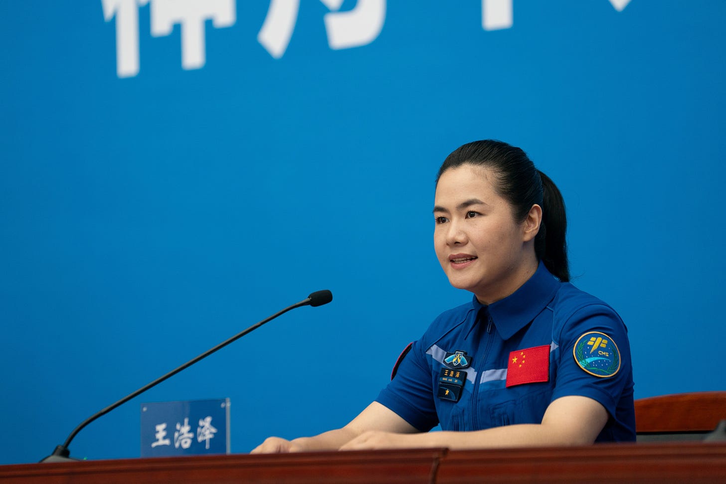 Shenzhou-19 Science Operator Wang Haoze speaks to the press.