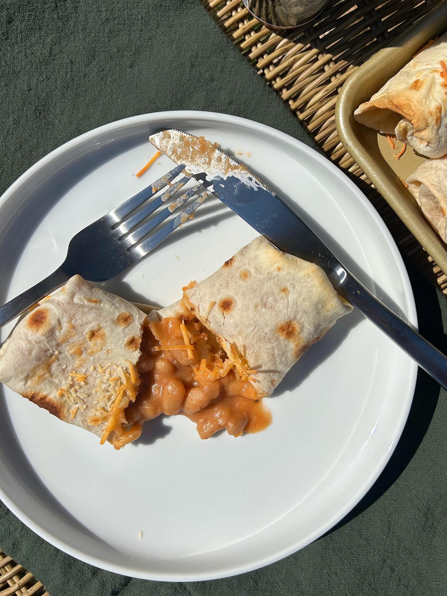 bean and cheese burrito on a white plate