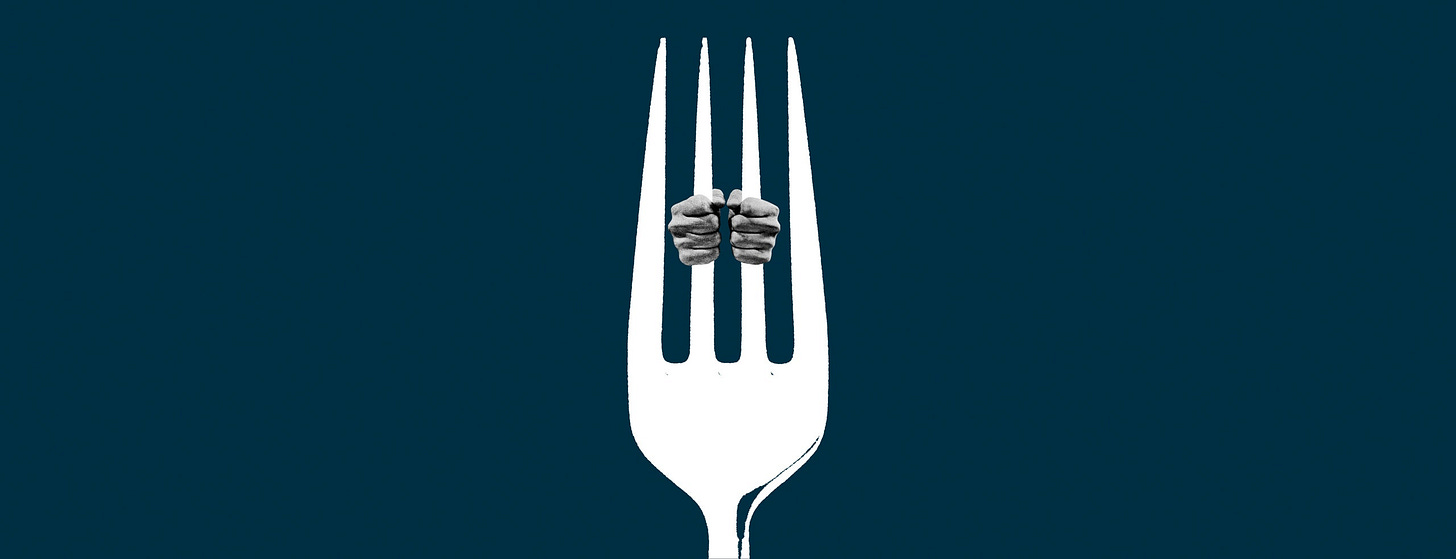 Hands holding onto the tines of a fork like prison bars.