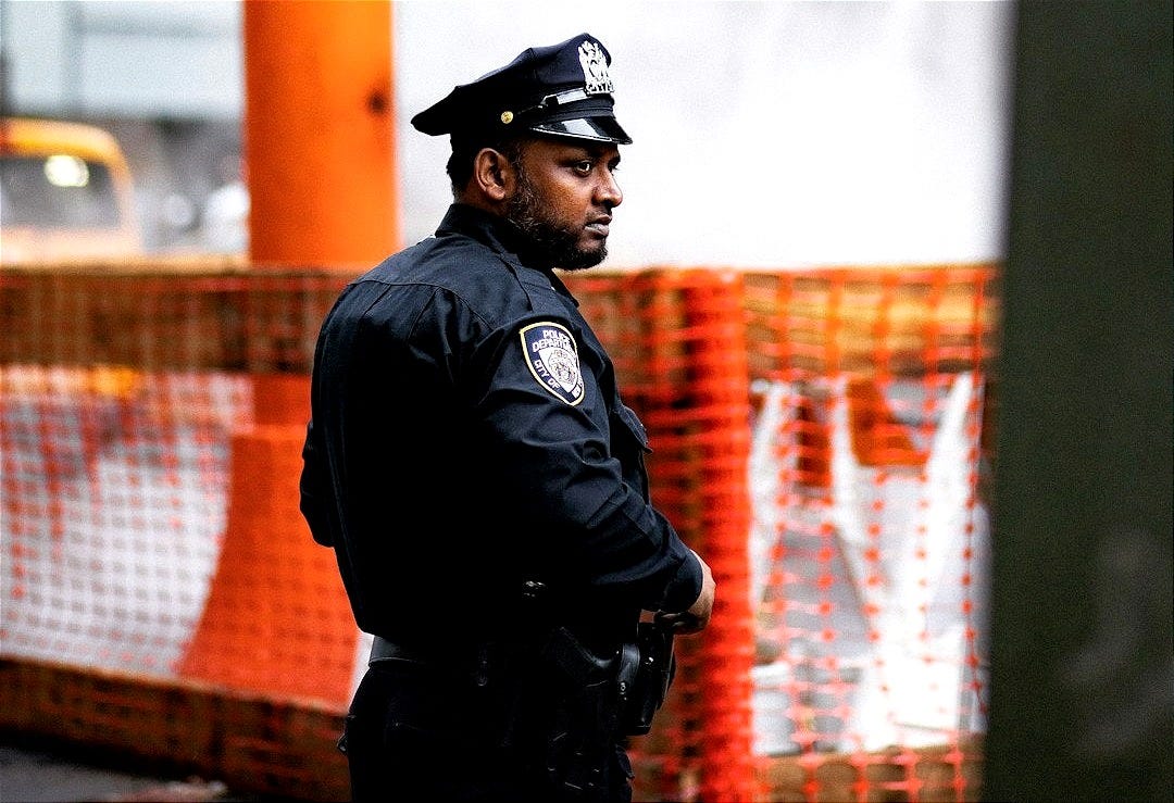 chief standing near body of water