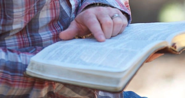 man reading bible man reading bible