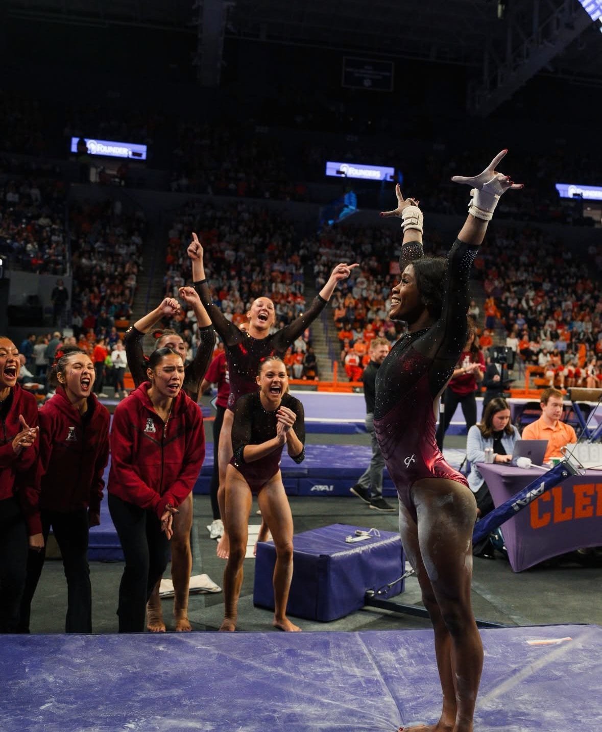Azaraya Ra-Akbar and her teammates after her first NCAA bar routine