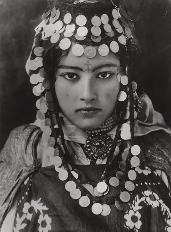 An Ouled Naïl Woman in traditional jewelry and dress in Algeria, 1910s.