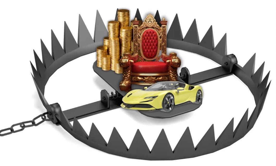 A bear trap with sharp metal jaws sits open on a white surface, containing symbols of wealth and power: stacks of gold coins, an ornate red and gold throne, and a yellow sports car. A chain extends from the trap, suggesting it’s part of a larger system designed to ensnare those who reach for these traditional markers of success.​​​​​​​​​​​​​​​​