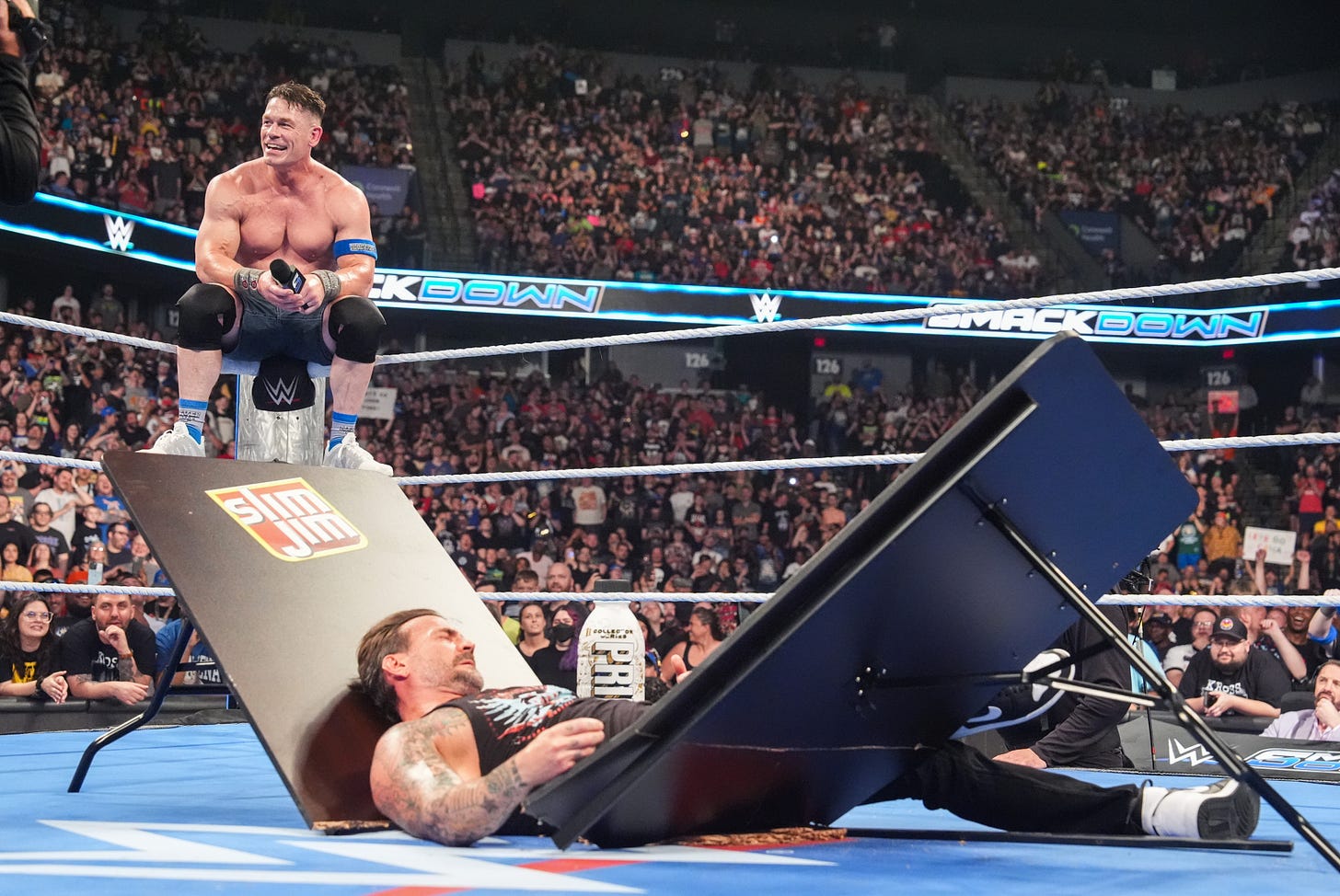 John Cena speaks his mind as CM Punk lies in the middle of a broken table