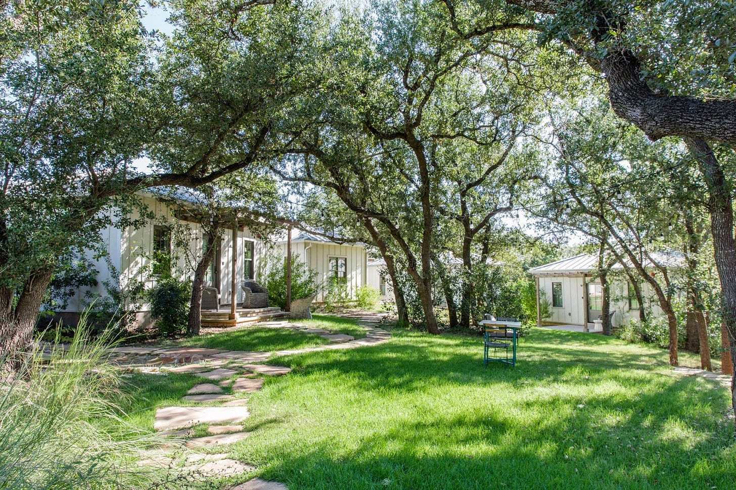 Cottages under heritage oaks at The Wayback, a cottage hotel near Austin, Texas