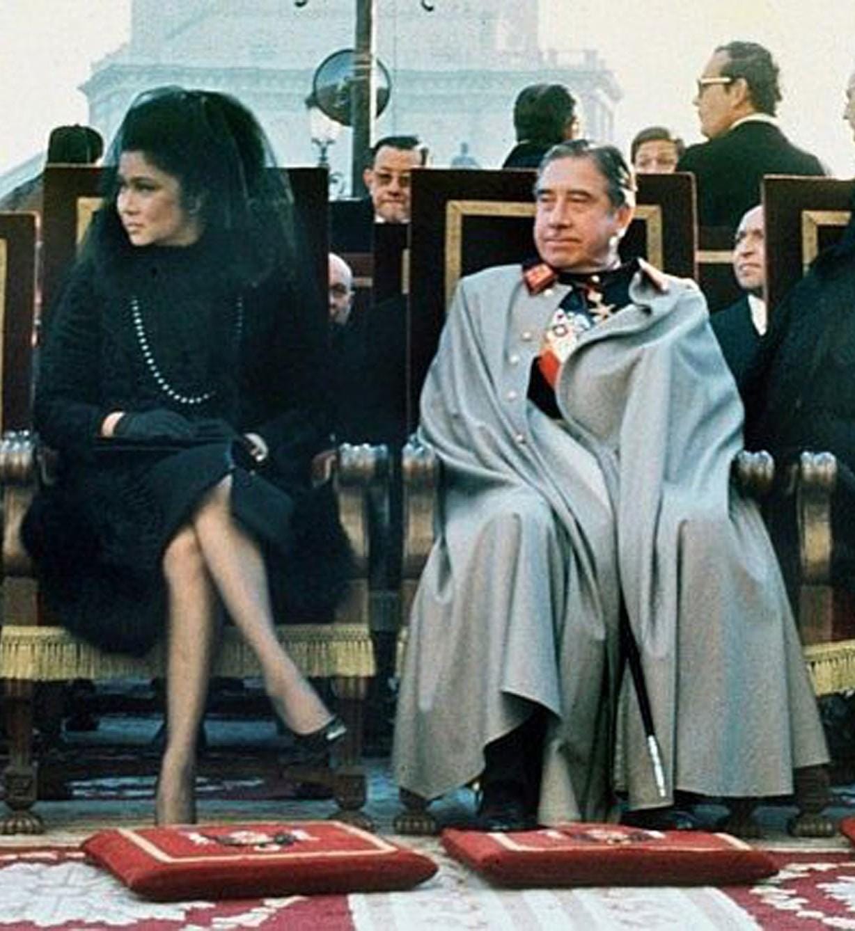 A gathering of authoritarian figures: Chilean dictator Augusto Pinochet seated next to Imelda Marcos, wife of Filipino dictator Ferdinand Marcos, at the funeral of Spanish dictator Francisco Franco, 1975.