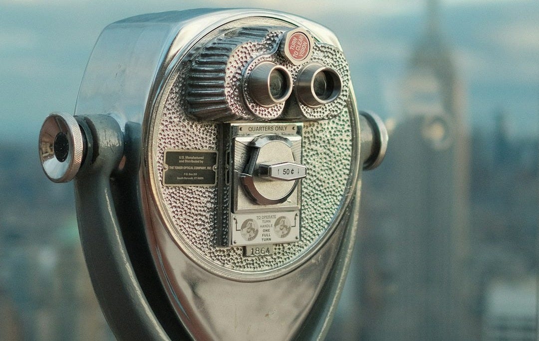 gray and blue coin operated binoculars