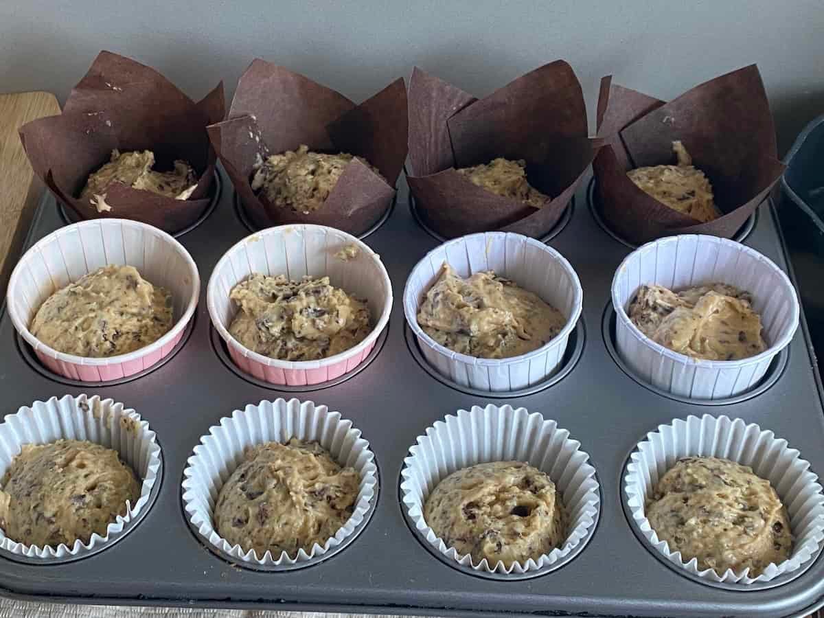 Paper cases filled with Muffin batter placed in a 12 holed muffin tin. Paper cases filled with Muffin batter placed in a 12 holed muffin tin.