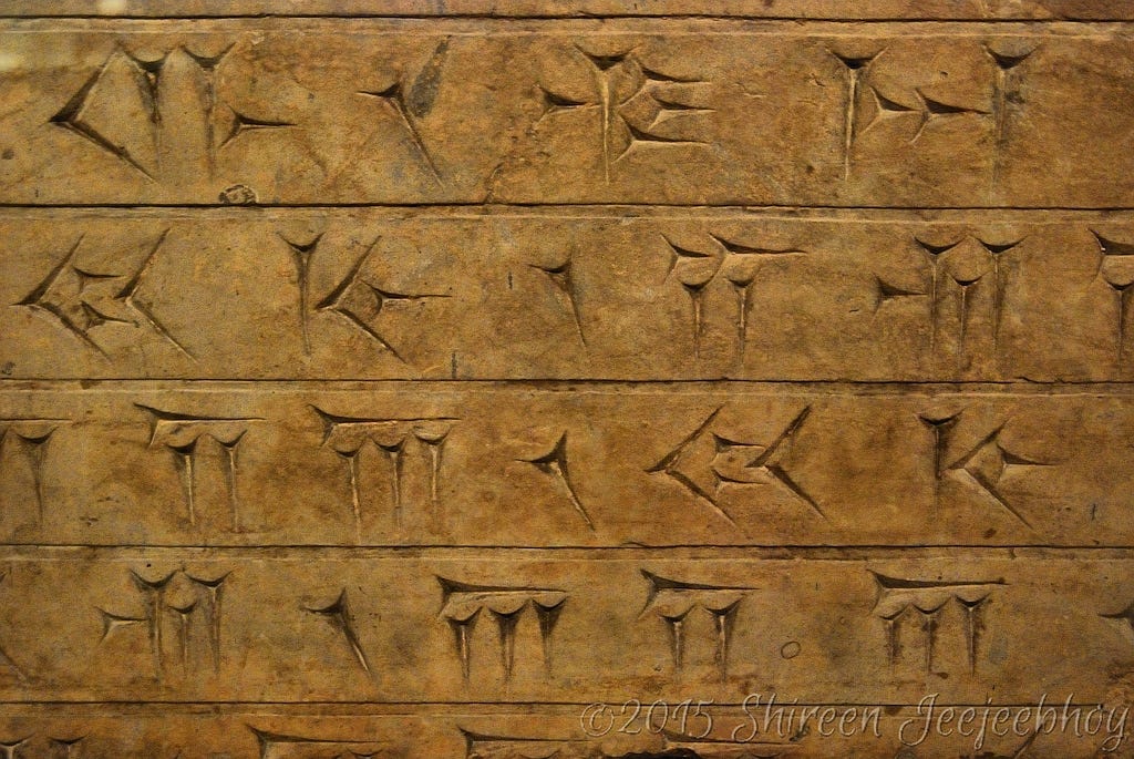 Close up of cuniform script carved into rock. Close up of cuniform script carved into rock.