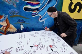 Celebrants sign large card for Ferlinghetti 1 Celebrants sign large card for Ferlinghetti 1