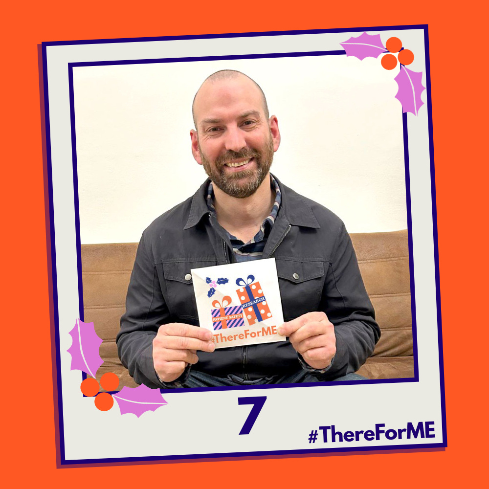 A pretend polaroid shows a smiling David Putrino posing for a photo holding a #ThereForME Christmas card.   The image on the card shows two presents, one labelled "patient safety", the other "research". The photo is labelled "7". The design is in the #ThereForME colours.
