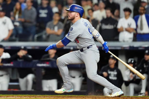 Gavin Lux of the Los Angeles Dodgers hits a sacrifice fly in the eighth inning during Game 5 of the 2024 World Series presented by Capital One...