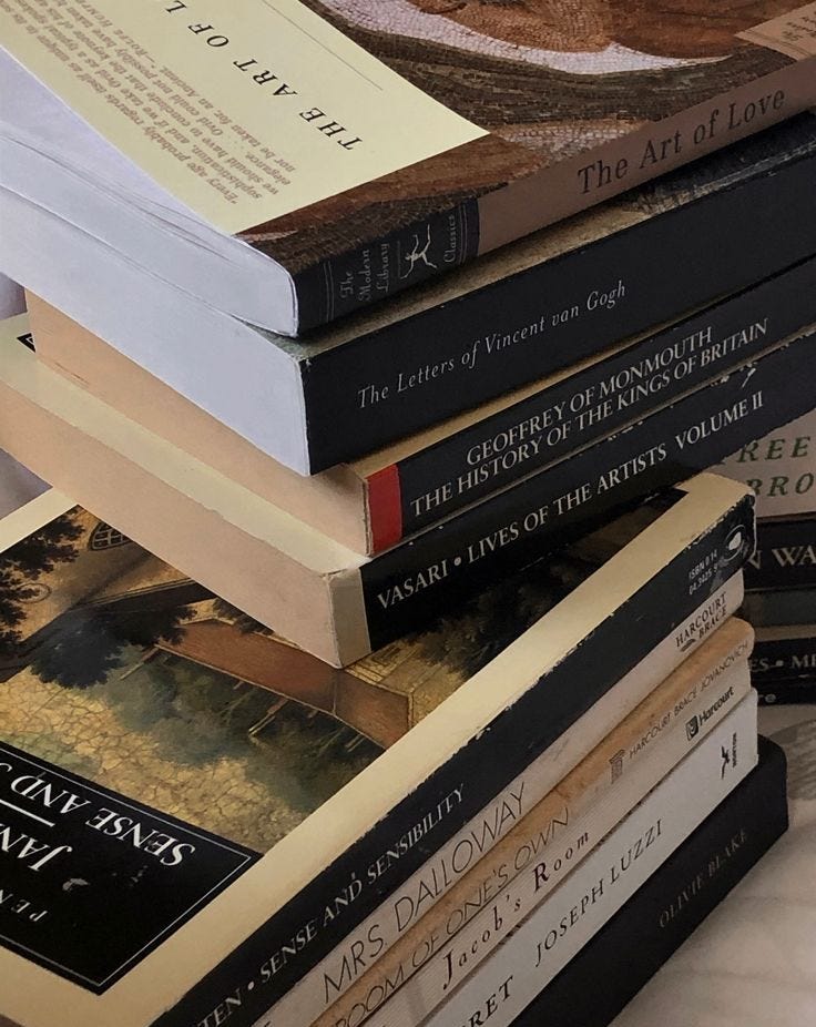 This may contain: a stack of books sitting on top of each other